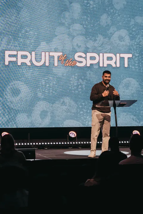 A speaker onstage in front of the video wall and stage lighting at Radiant Church’s Odessa location.