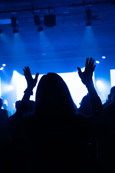 Stage lighting and overhead fixtures seen from the congregation at Radiant Church’s South Shore location.