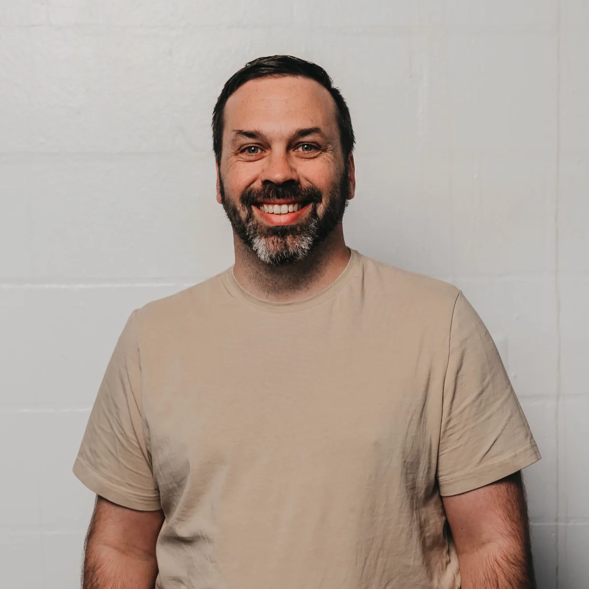 Sam Cornwell smiling in a light shirt